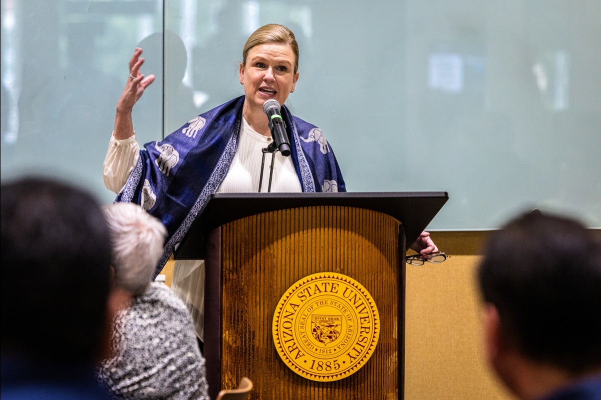 A woman speaks at a lectern