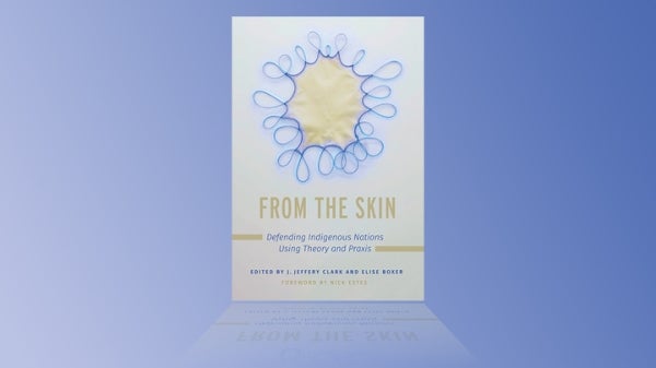 Photo of the cover from "From the Skin" on a light blue background.
