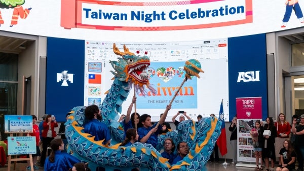 Dancers hold a large dragon puppet