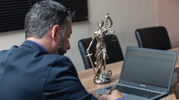 Man sits working on a laptop