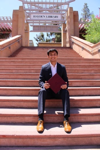 Portrait of Gaurav Gondane holding a graduation cap